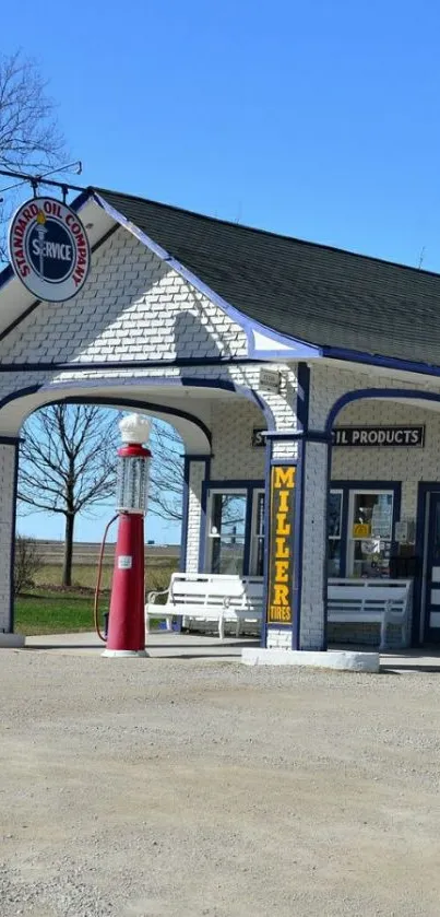 Vintage gas station with retro design against a clear blue sky.