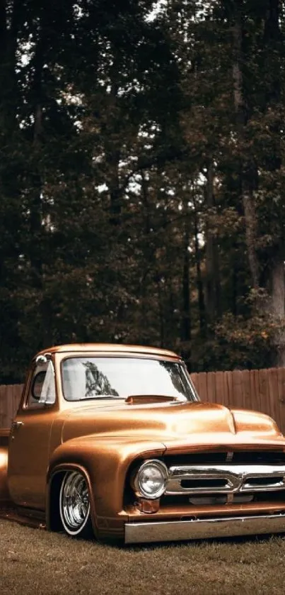 Vintage golden truck parked in a forest setting.