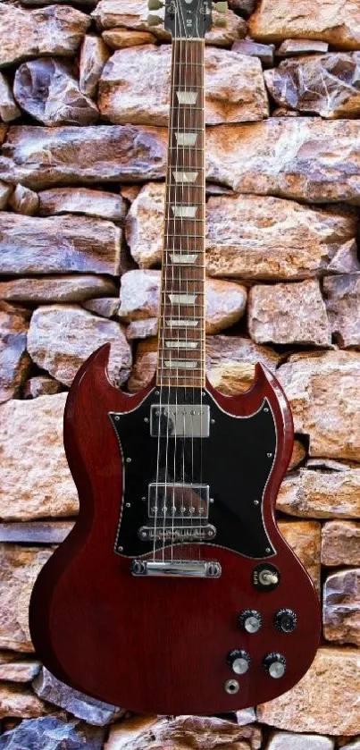 Vintage guitar against a stone wall wallpaper.