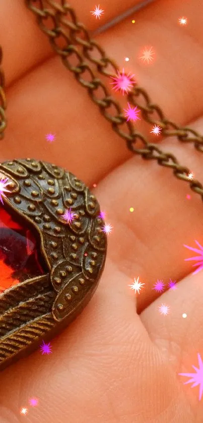 Vintage heart pendant with red gemstone on a hand
