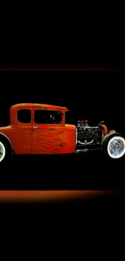 Vintage hot rod with orange flames on black background.