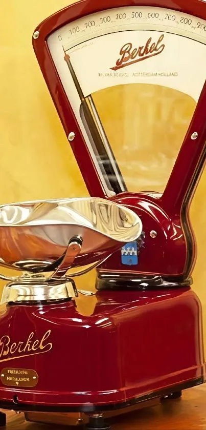 Vintage Berkel kitchen scale with red design on yellow background.