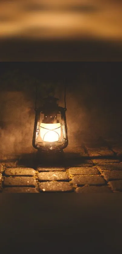 Vintage lantern casting warm glow on cobblestone path, ideal for mobile wallpaper.