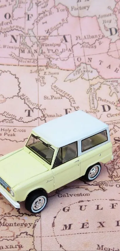 Vintage map with toy car in soft pink tones.