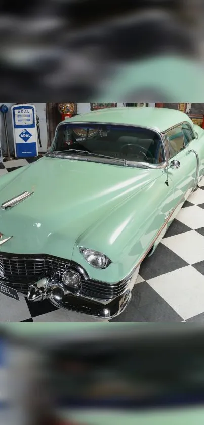 Vintage mint green car with classic design on checkerboard floor.