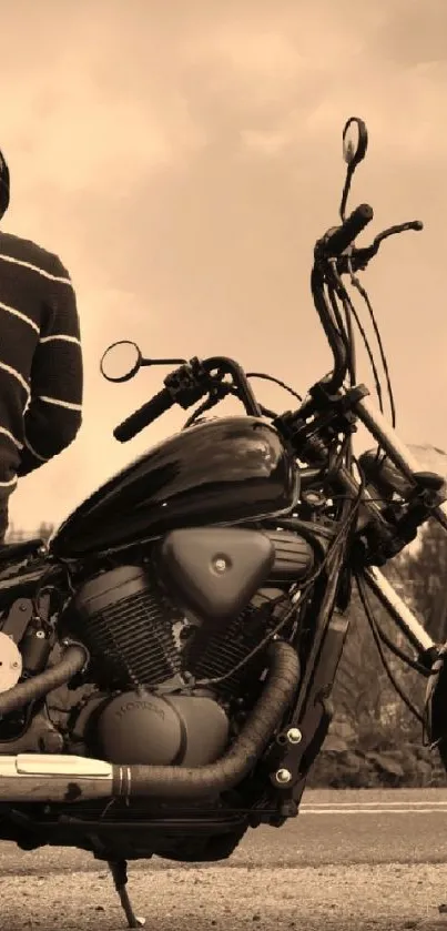 A person sitting on a vintage motorcycle on a countryside road, in sepia tones.