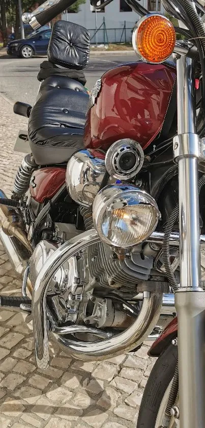 Close-up view of a vintage motorcycle with chrome details and a crimson red gas tank.