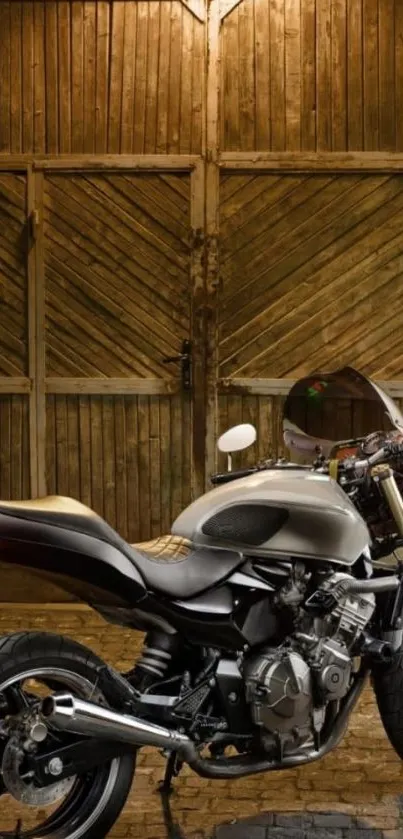 Vintage motorcycle parked in a rustic wooden garage with warm lighting.