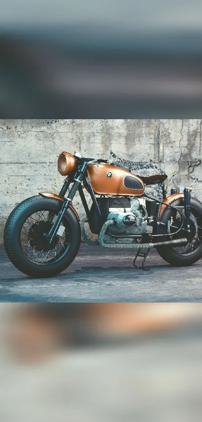 Vintage motorcycle with copper finish against a rustic wall background.