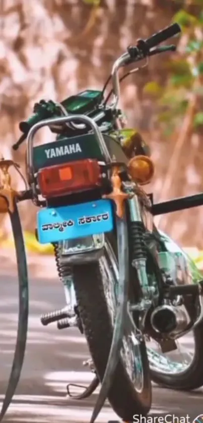 Rustic Yamaha motorcycle on road with a vintage vibe.