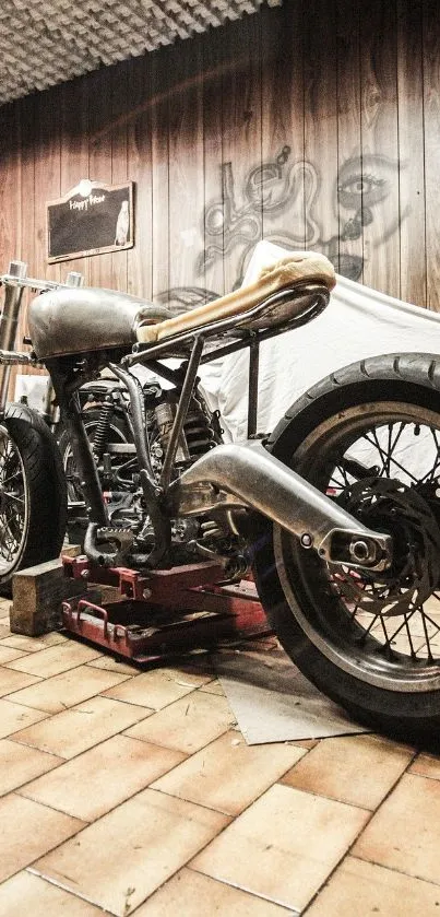 Rustic vintage motorcycle in workshop setting with wooden backdrop.