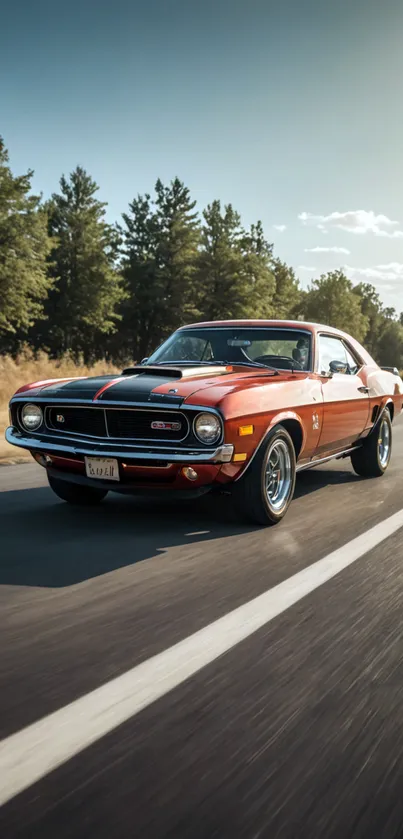 Vintage muscle car on scenic road with trees under clear sky.