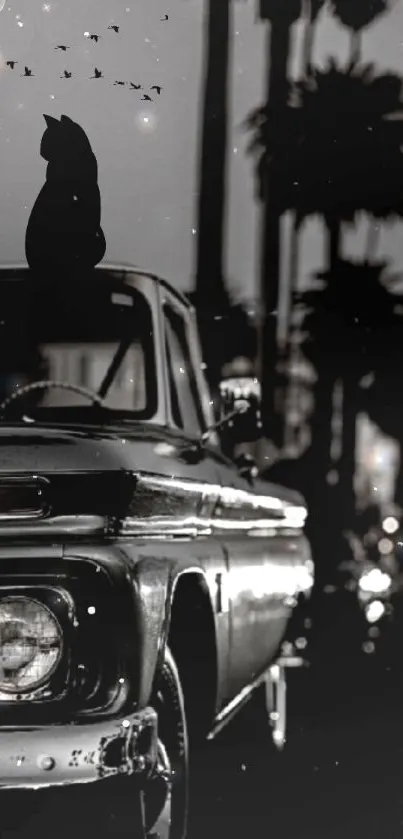 Black and white wallpaper of vintage car, cat silhouette, and cityscape at night.
