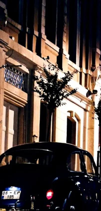 Vintage car parked on illuminated street at night.