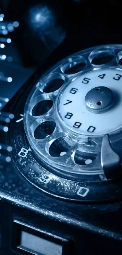 Vintage rotary phone with blue tint and intricate dial design.