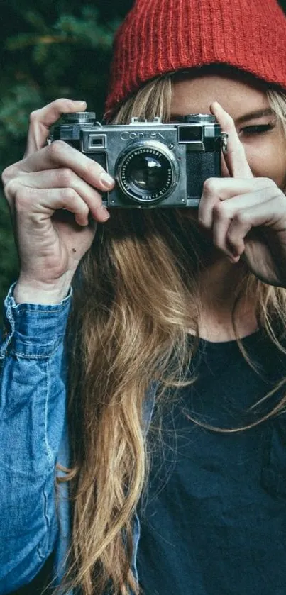 Girl with vintage camera in nature backdrop.