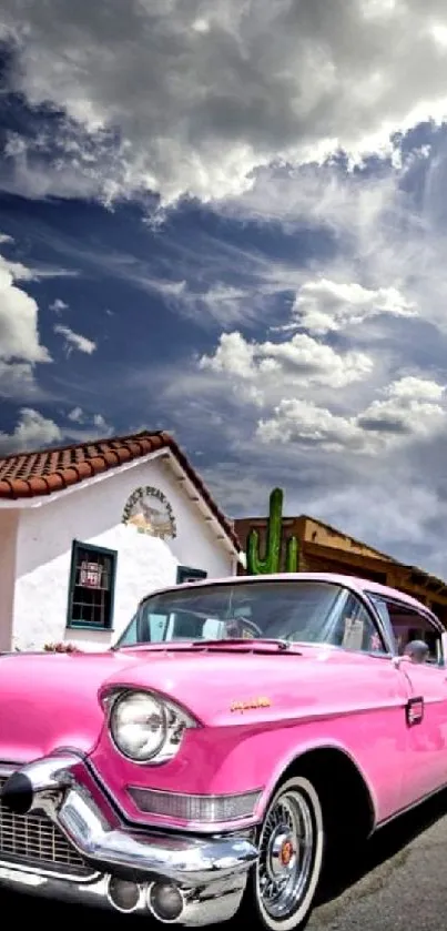 Classic pink Cadillac under cloudy skies wallpaper.