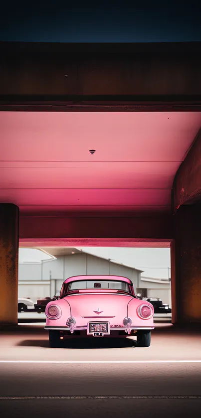 Vintage pink car parked under a vibrant pink-lit urban overpass.