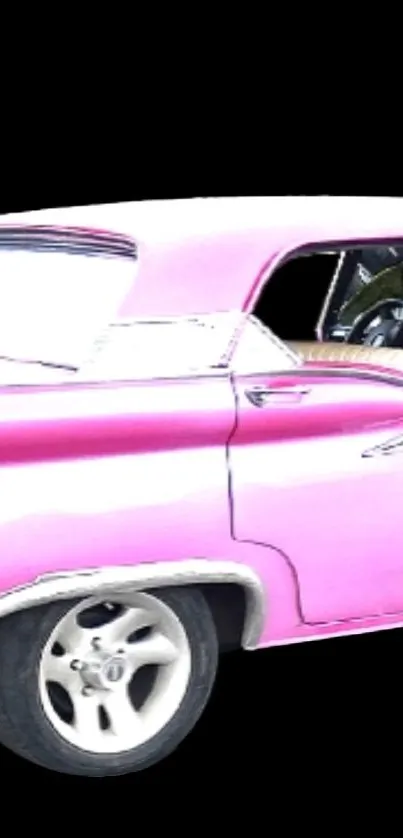 Vintage pink car on a black background.