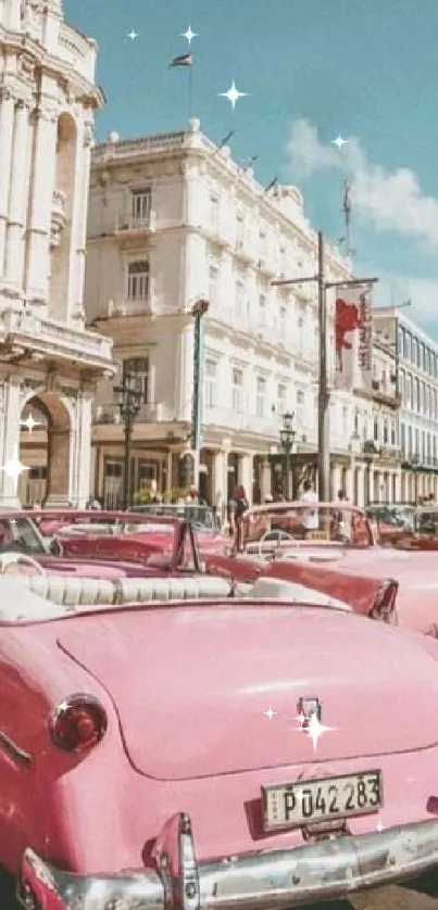 Vintage pink cars in colonial cityscape.