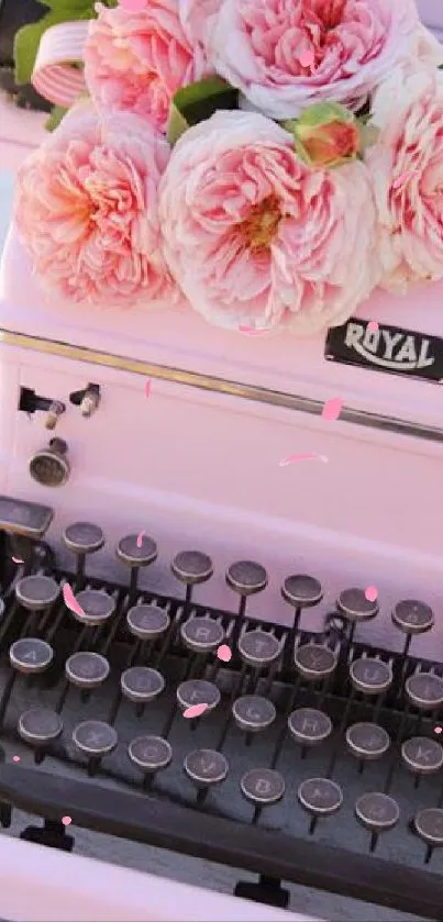 Vintage pink typewriter with flowers on top, creating a charming look.