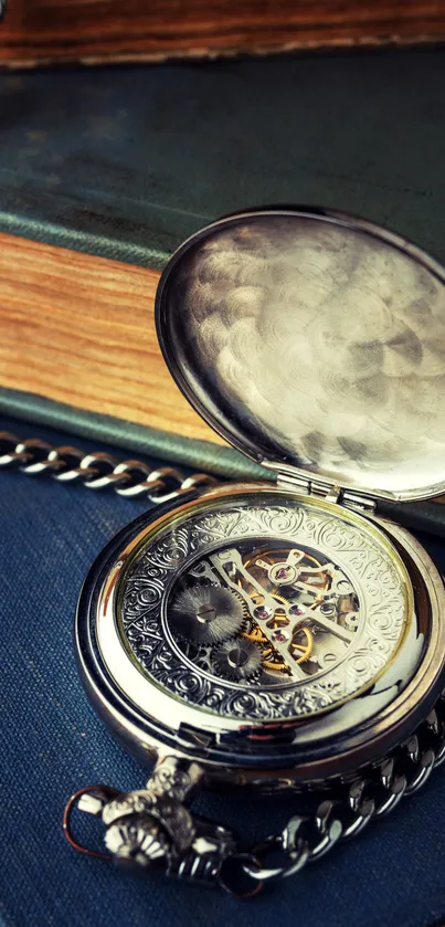 Vintage pocket watch resting on books with a silver chain.