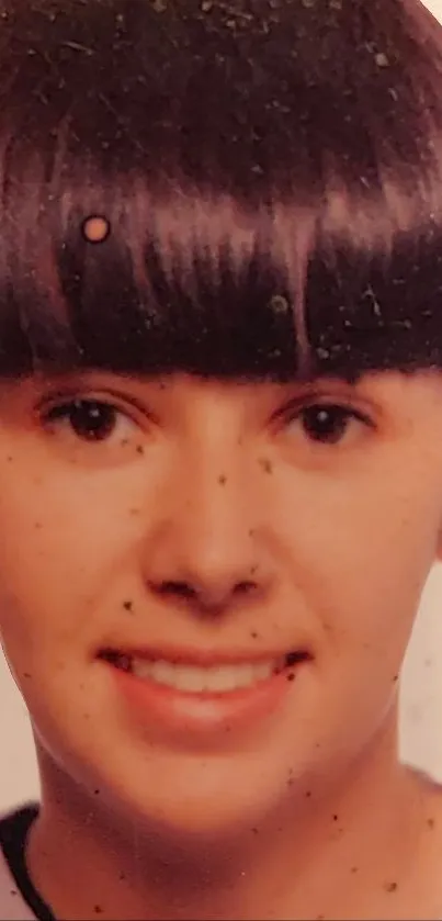 Vintage-inspired portrait of a young person with a distinctive fringe hairstyle.