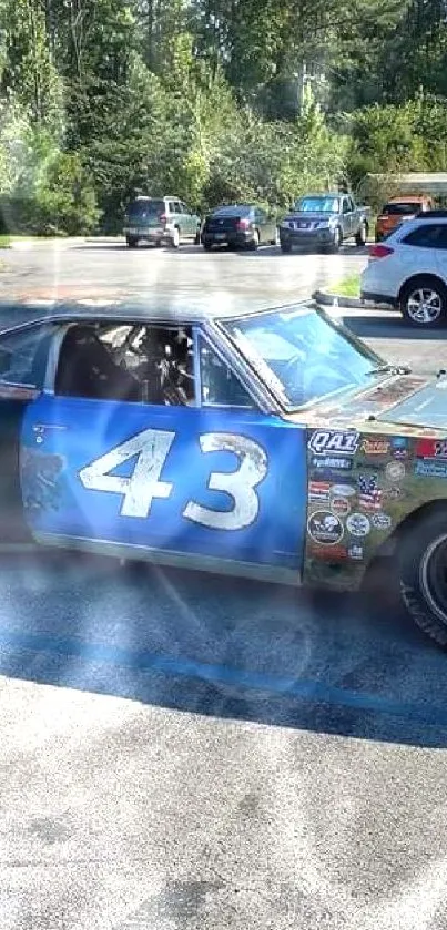 Vintage race car parked outdoors on a sunny day.