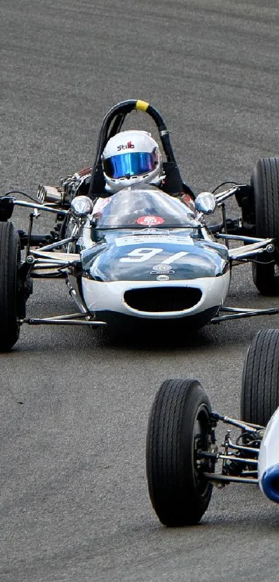 Vintage racing car on track, showcasing speed and classic design.