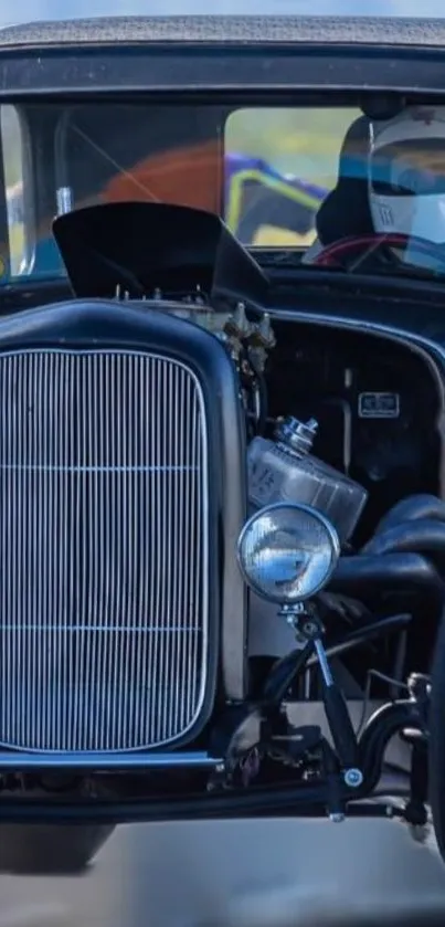 Vintage racing car in motion with driver wearing a helmet.