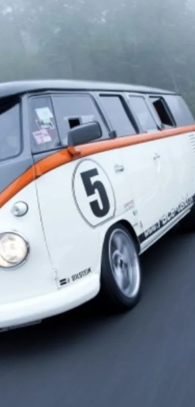 Vintage racing van with orange stripe on a foggy road.