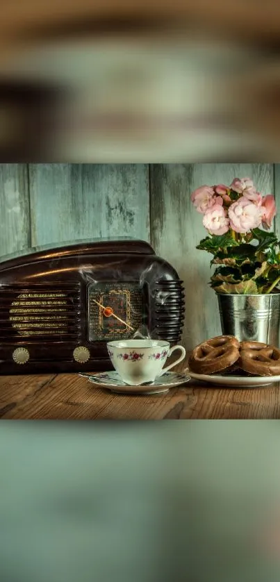 Vintage radio, tea cup, and flowers on a rustic wooden table.