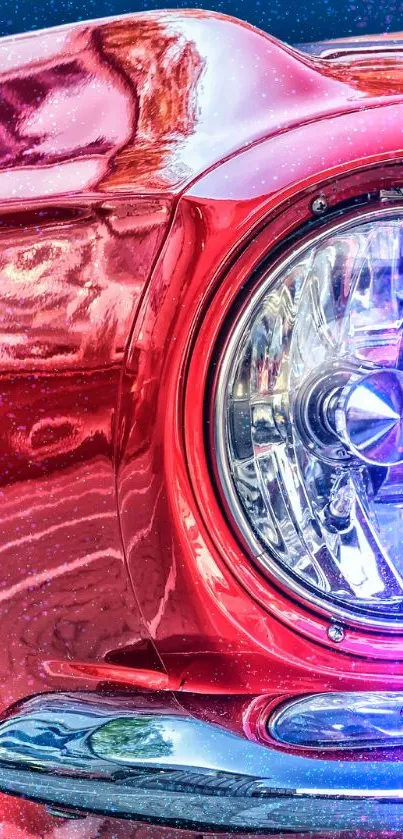 Close-up of a vintage red car with a focus on the headlight.