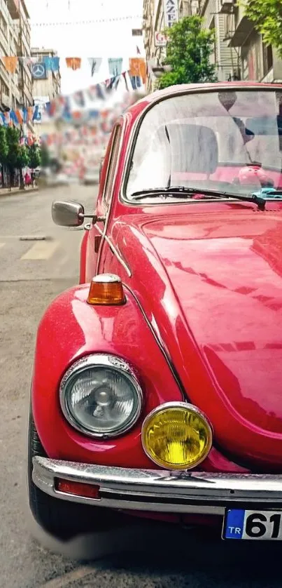 Vintage red car on urban street wallpaper.