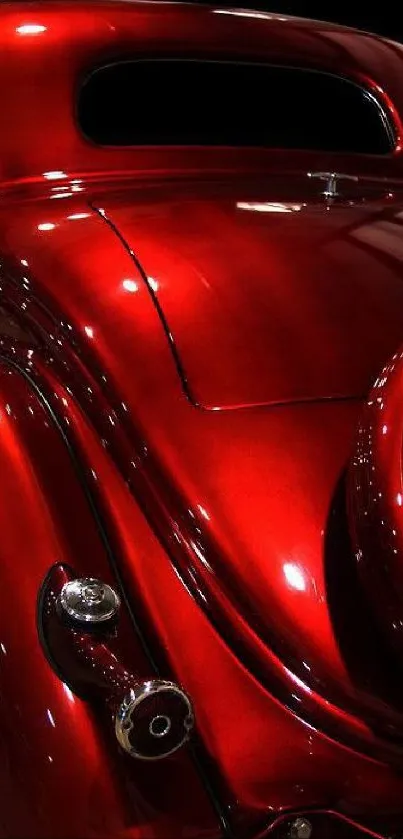 Sleek vintage car with shiny red finish in elegant design.