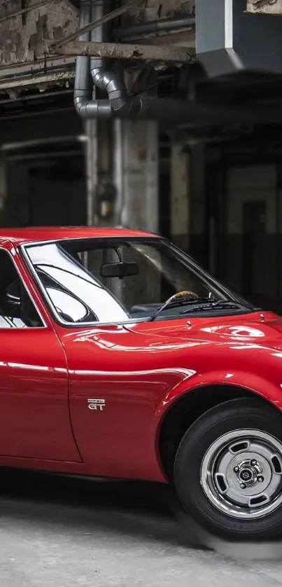 Vintage red car in a rustic garage setting, perfect for wallpapers.