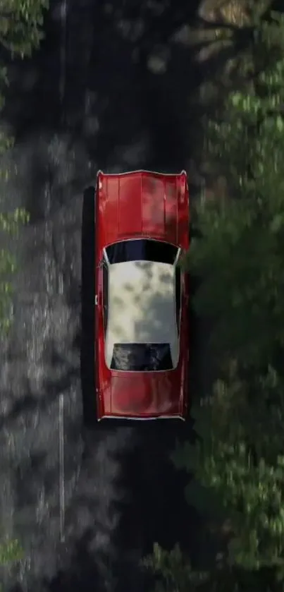 Aerial view of a red vintage car amidst green trees.