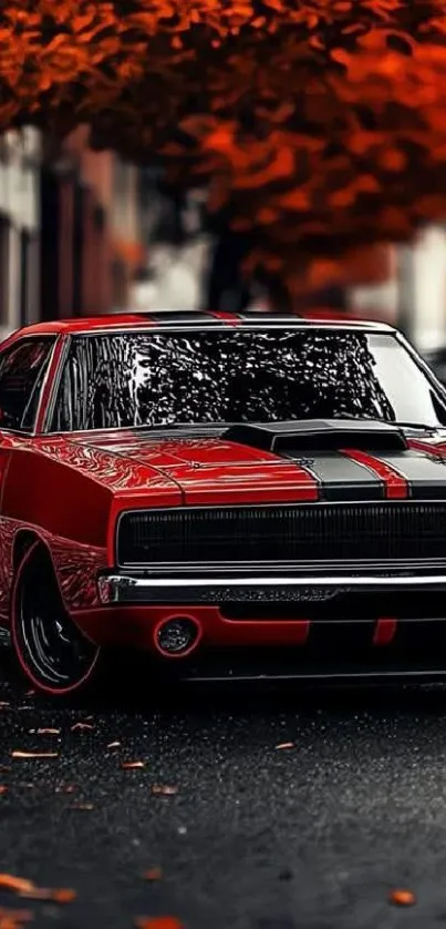 Vintage red car parked on autumn street with fallen leaves.