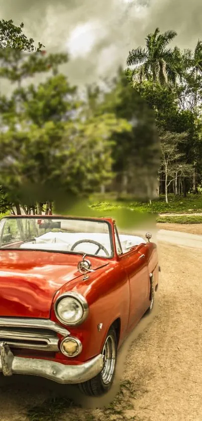 Red vintage convertible on a scenic road.