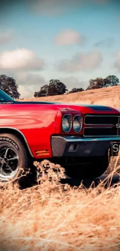 Red vintage muscle car in scenic field.