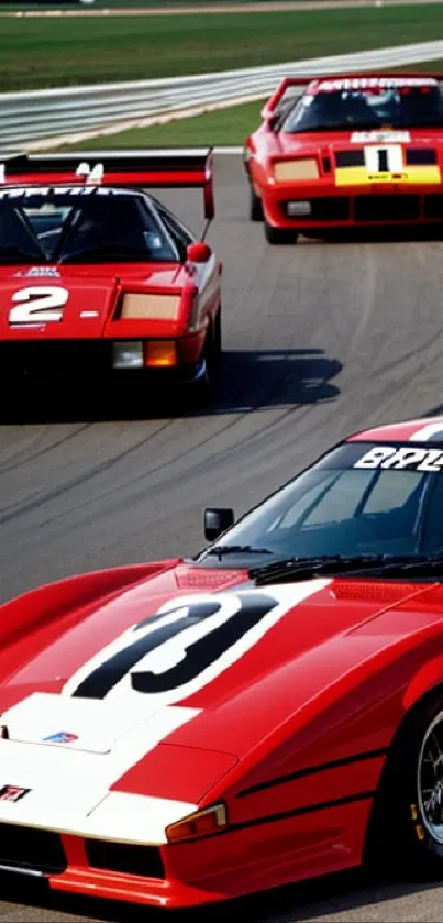 Vintage red race cars on a track, capturing speed and elegance.