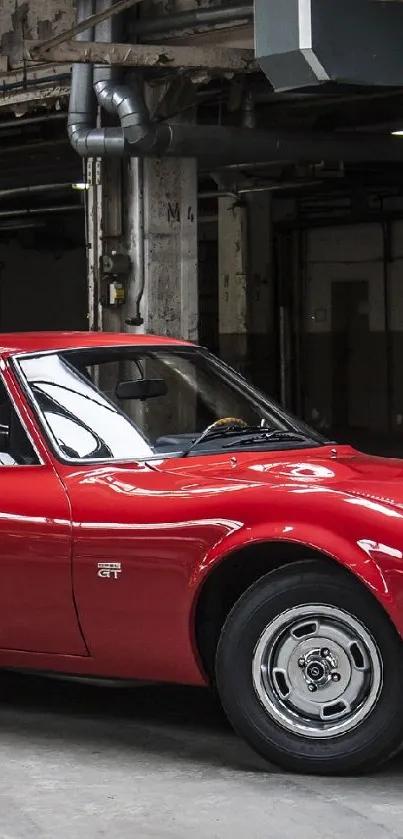 Red vintage sports car in industrial building.