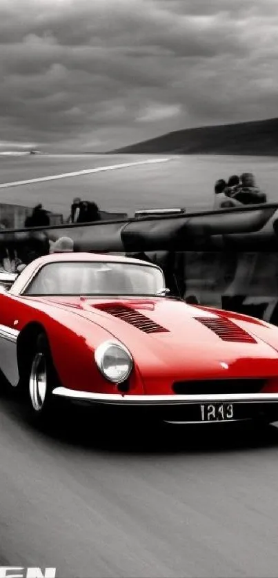 Vintage red sports car speeding on a race track.