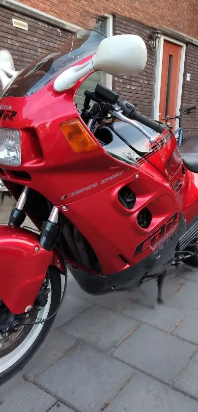 Vintage red sports motorcycle parked on street.