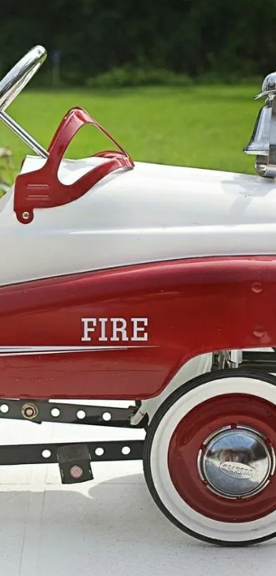 Vintage red toy fire truck pedal car mobile wallpaper.