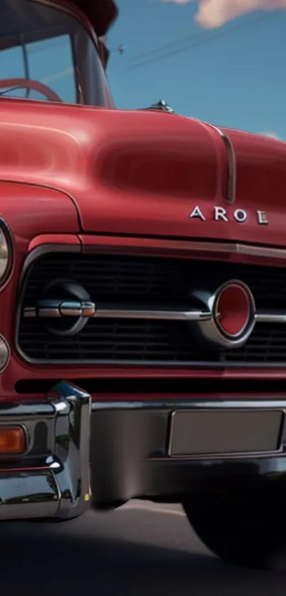 Vintage red truck with chrome details under a clear blue sky.