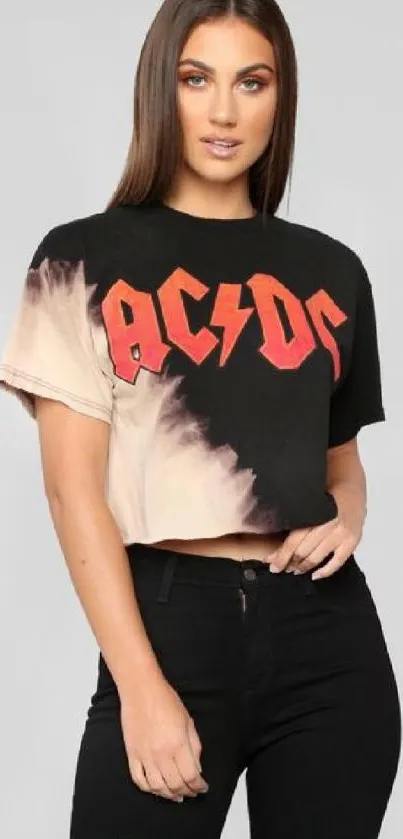 Fashionable woman in vintage rock band tee with black jeans.