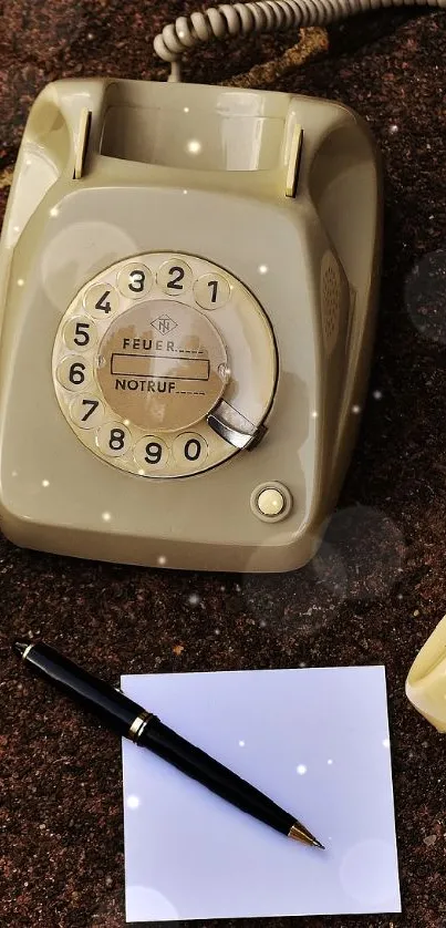 Vintage rotary phone and stationery on rustic surface.