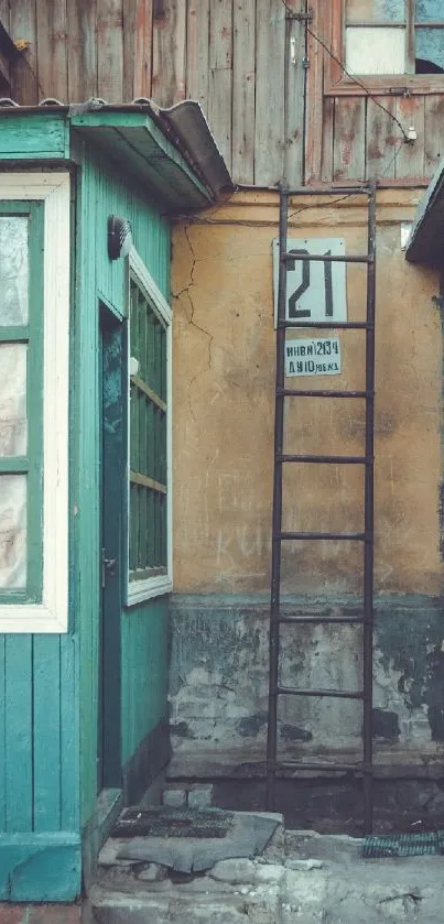 Vintage rustic building with teal and mustard colors, featuring ladder and windows.