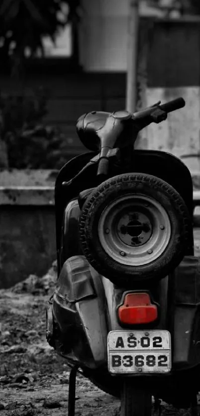 Vintage scooter in black and white urban setting.